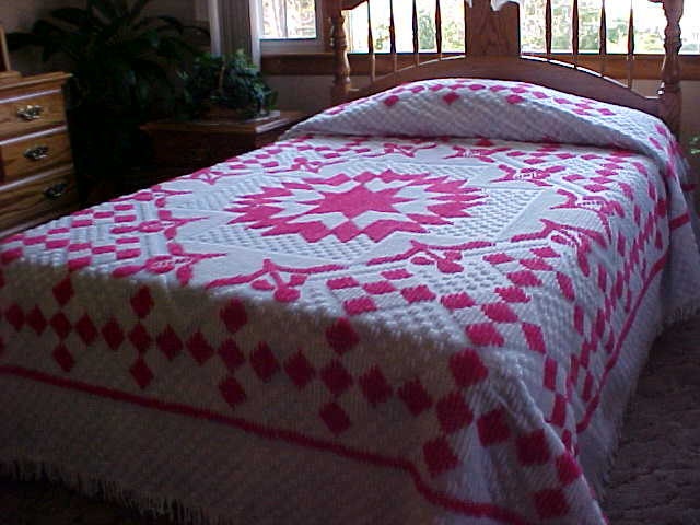 Beautiful 70's chenille bedspread pink starburst pattern on white background