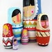 handmade wood folk art nesting dolls... wool sweater Eskimos