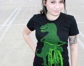 Ladies TYRANNOSAURUS REX Dinosaur on a BICYCLE  Black T-Shirt - American Apparel - S  M  L  xL