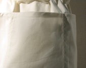 Bernadette's personalized muslin half apron, large roomy pockets, tie pulls through casing around waist to adjust, embroidered with initials