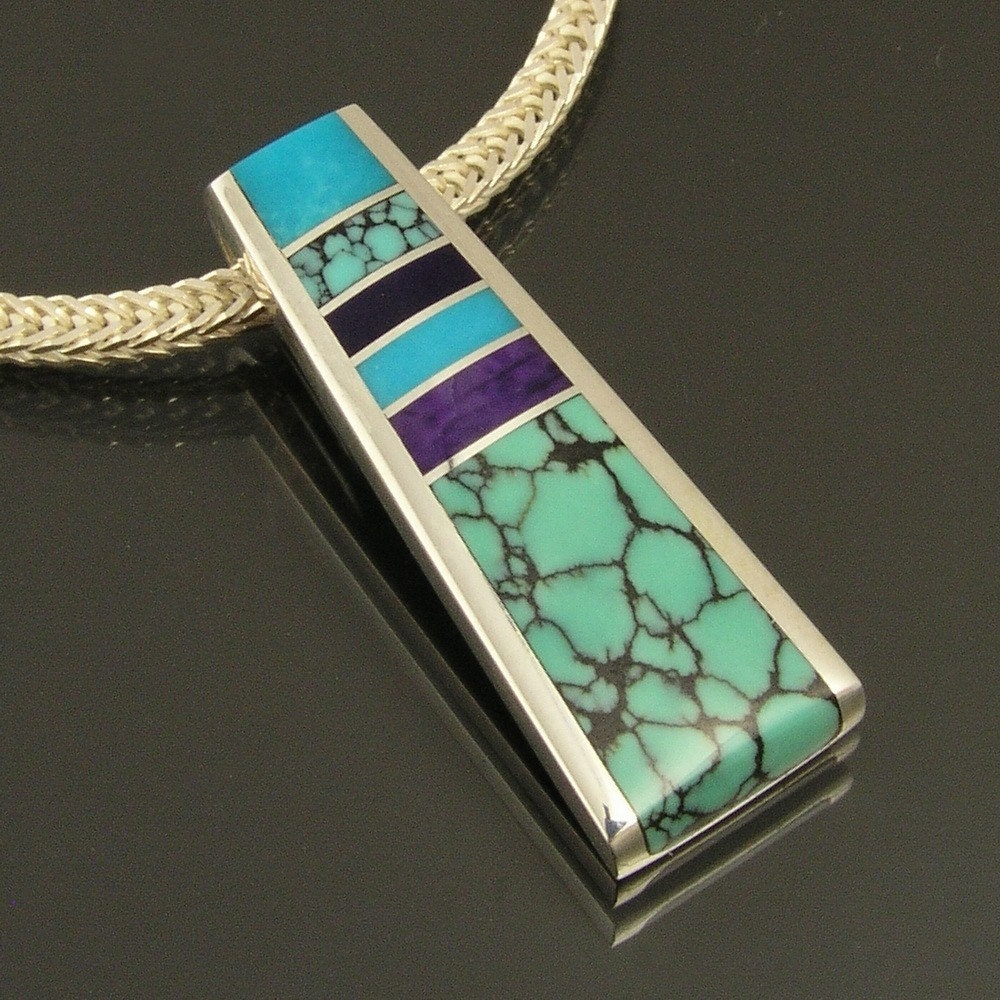 Sterling silver pendant by Mark Hileman inlaid with spiderweb turquoise, sugilite and turquoise.