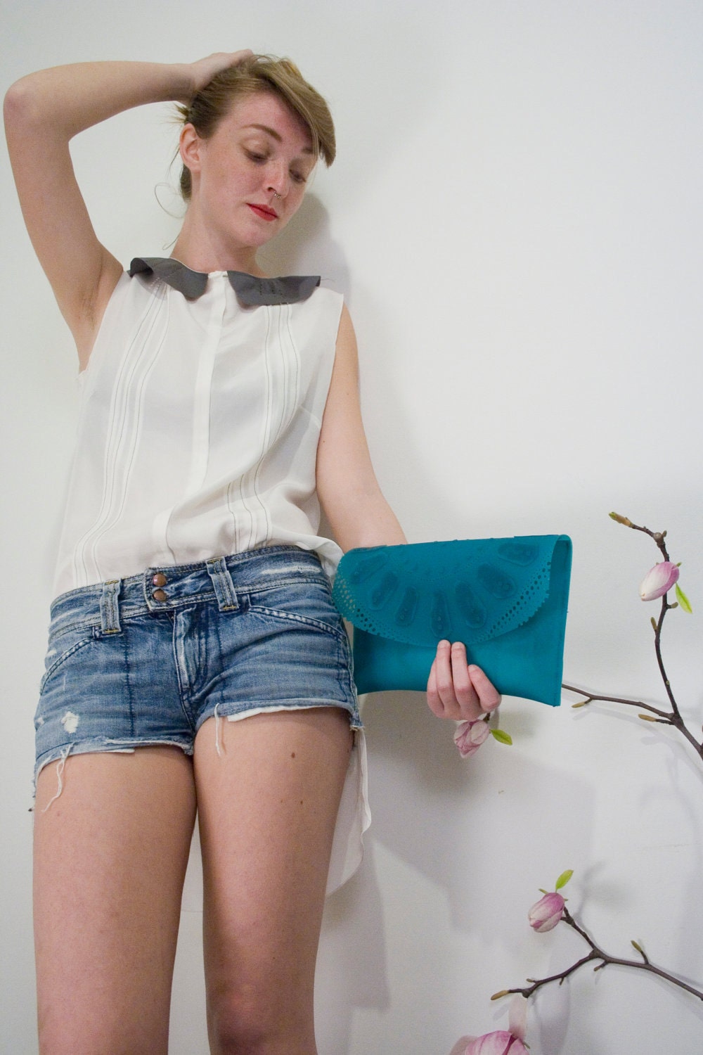 Turquoise lace pattern clutch bag in rubber.
