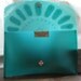 Turquoise lace pattern clutch bag in rubber.
