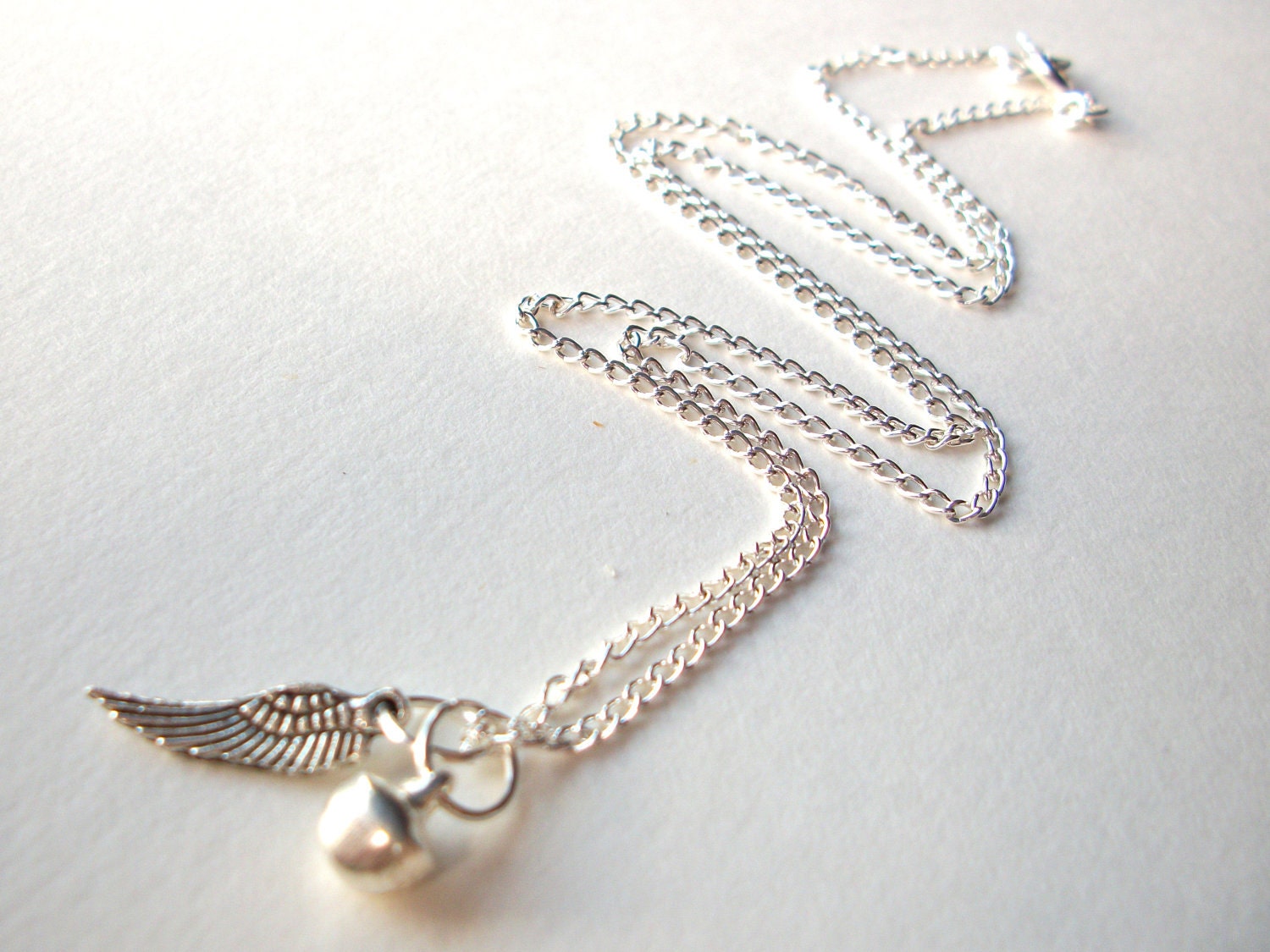 Miscarriage necklace, silver angel wing and tinkling bell charms on silverplated chain infant loss remembrance