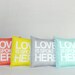 Love is Spoken Here 14"x14" pillow in coral pink