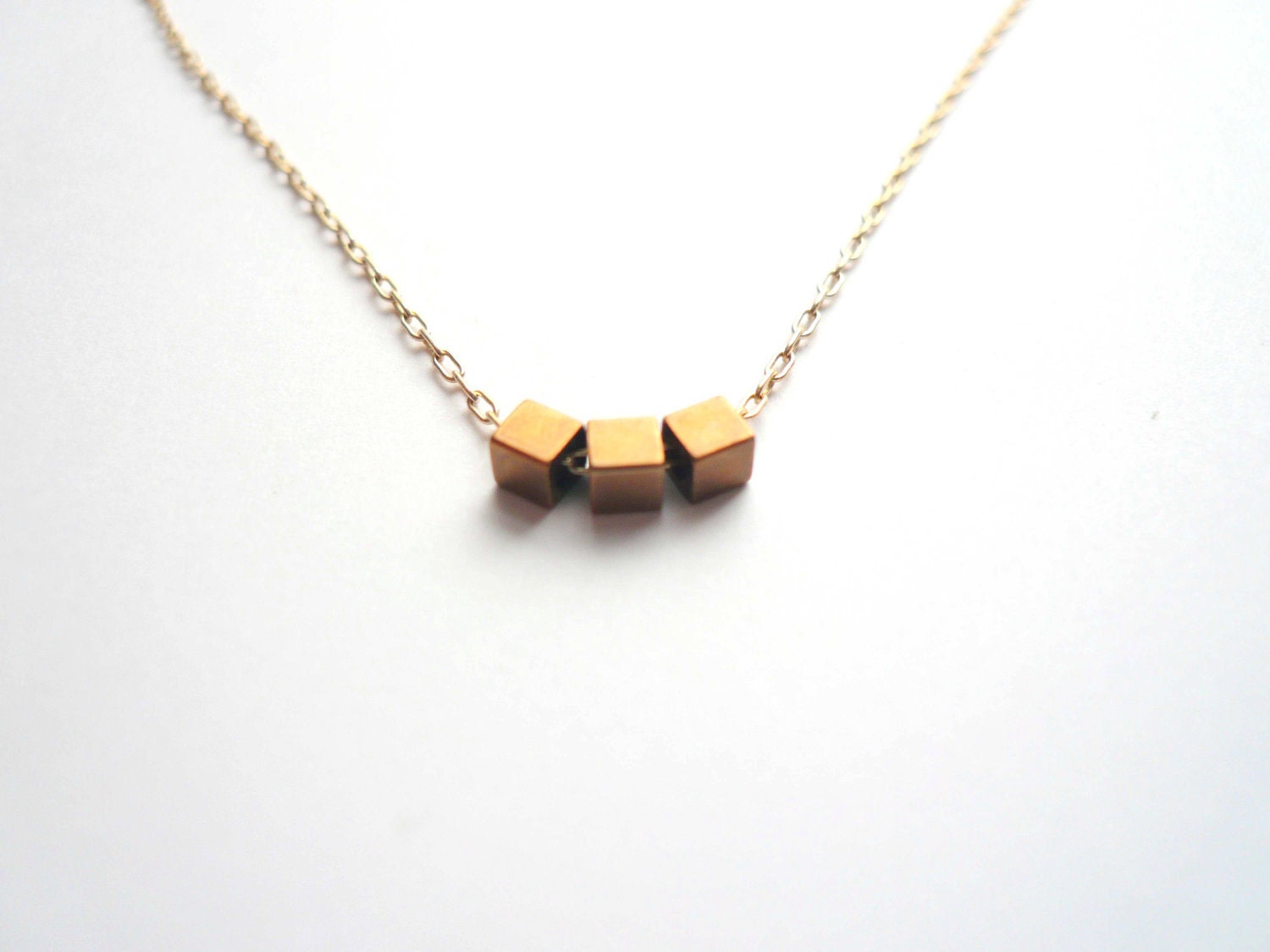 Gold geometric necklace. Dainty jewelry. Tiny vintage brass cubes on sweet 14K gold fill chain.