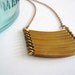 Brass geometric necklace with military style curved brass bars. Stacked bar necklace.