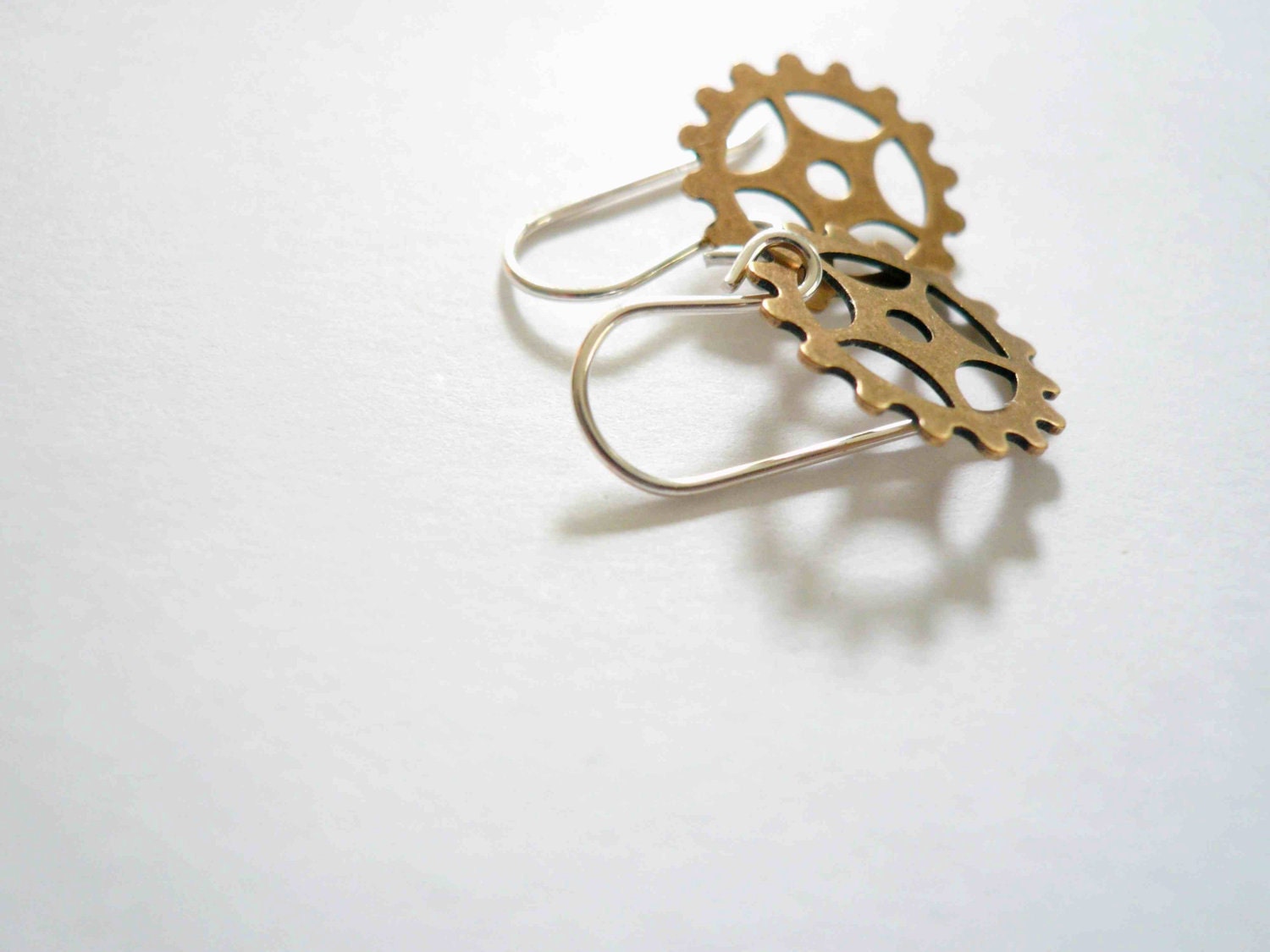 Steampunk gold earrings. Delicate brass clock gears on sterling silver.