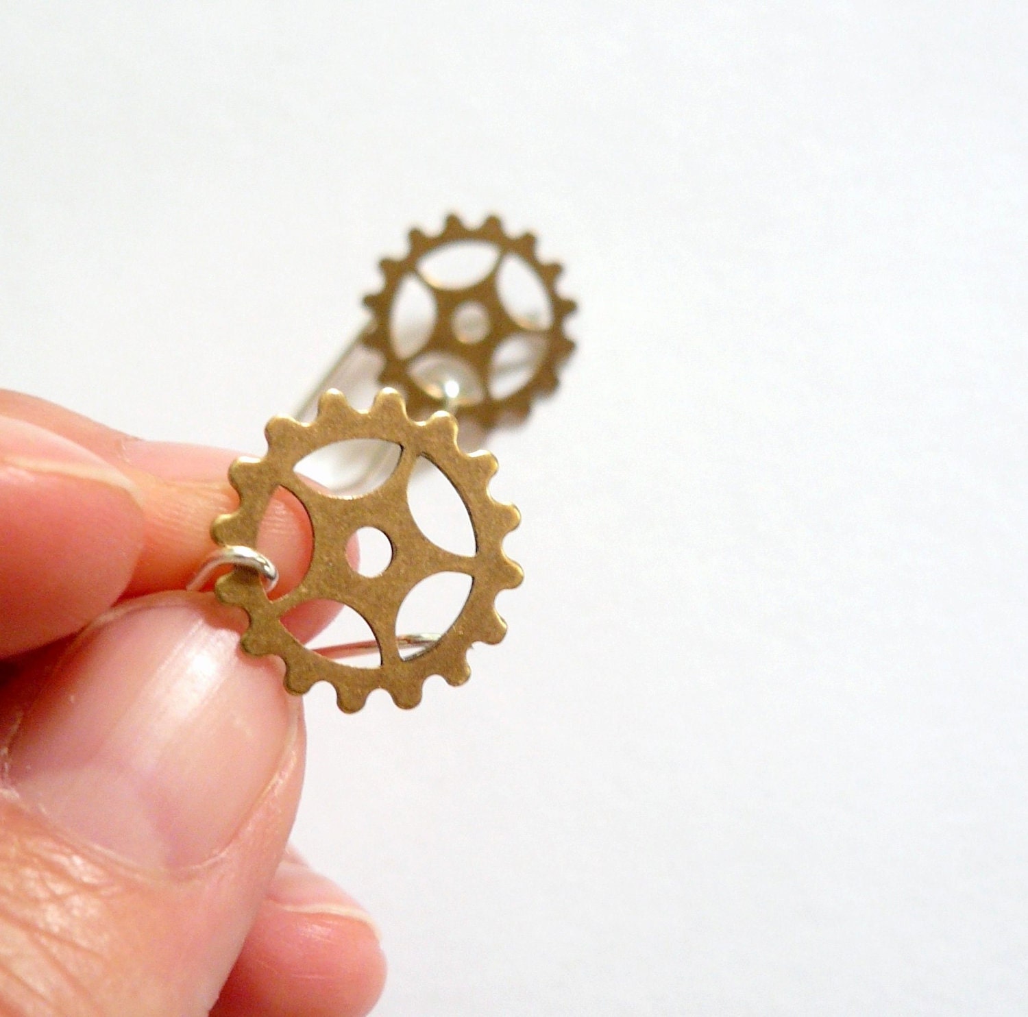 Steampunk gold earrings. Delicate brass clock gears on sterling silver.