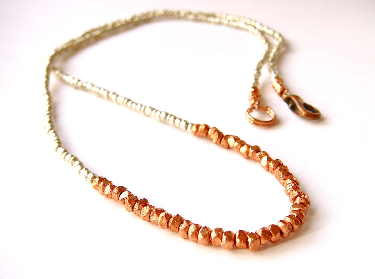 old letters // necklace / bracelet with mini chunky geometric copper beads on silver seed bead background