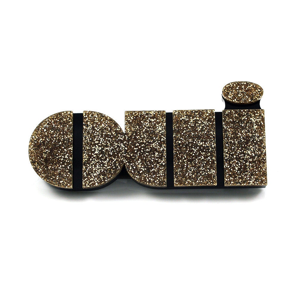 Oui brooch in gold glitter perspex