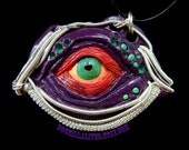 Wire wrapped monster eye made with painted polymer clay
