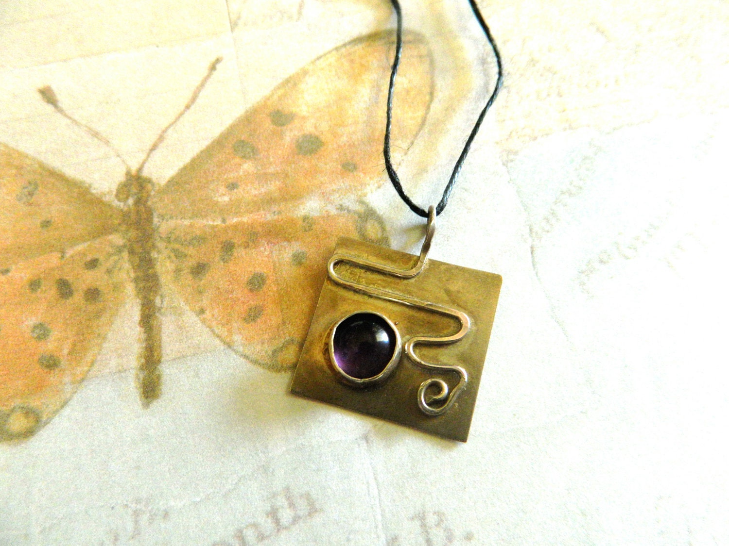 Sterling Silver pendant with hand bezeled Amethyst cabachon