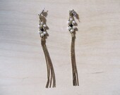 Dangle earrings with pearl accents.