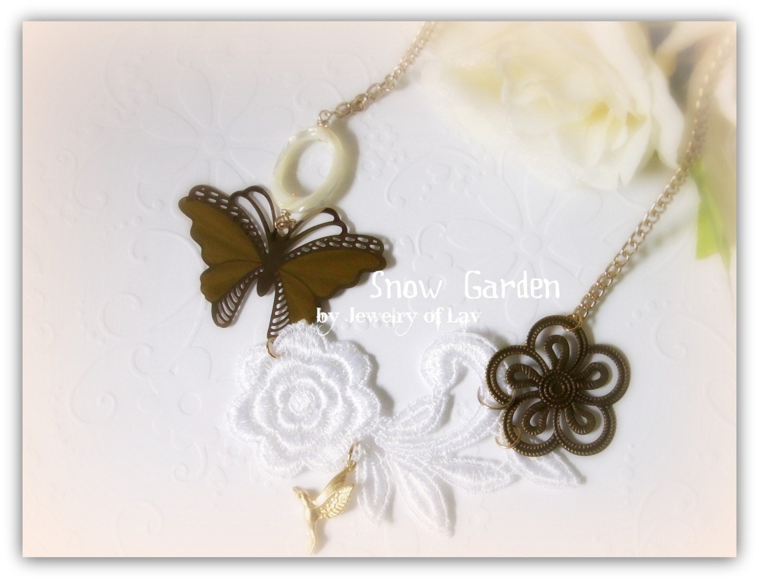 Snow Garden necklace with flower lace, butterfly charm, humming bird charm, filigree charm, mother of pearl ring etc.