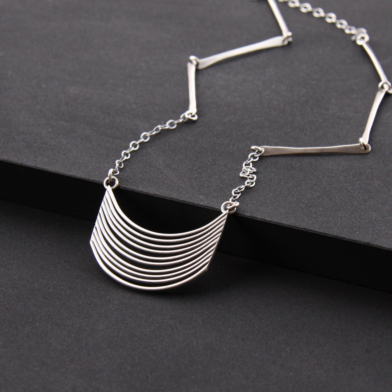 Long boho style sterling silver necklace with a unique pendant handmade by joining flattened and curved silver wires - "Tribe Necklace"
