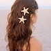 Two small white knobby starfish barrettes.