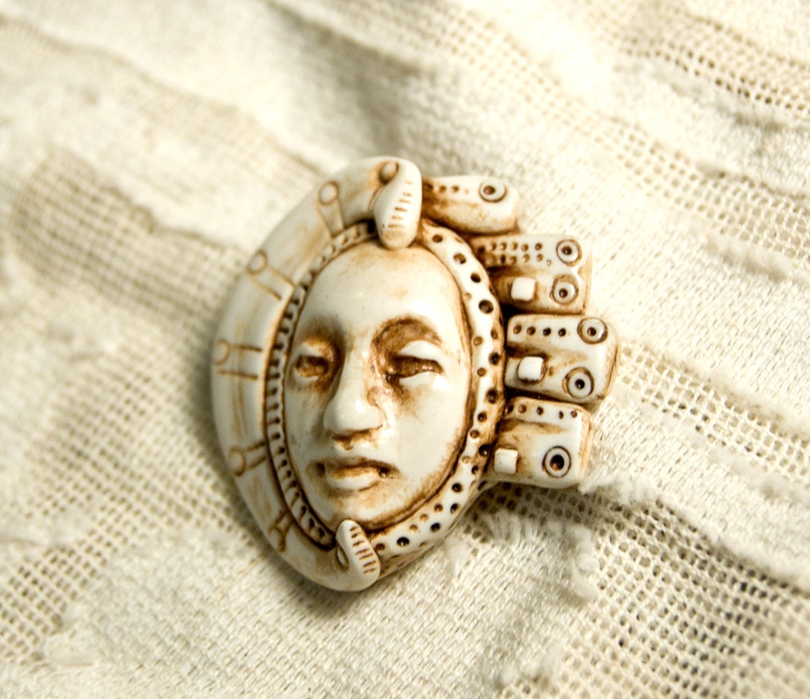 faux ivory face pendant with geometric ornament