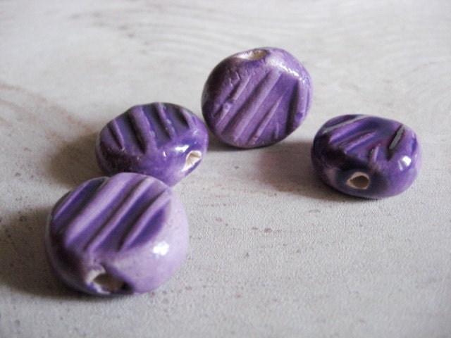 Set of four handmade ceramic beads purple coins wth raised linear texture