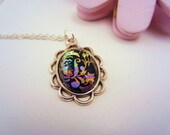 Black and iridescent silver necklace. Rainbow detail. Scalloped frame pendant charm. Cabochon.  Pink, blue, gold, purple.