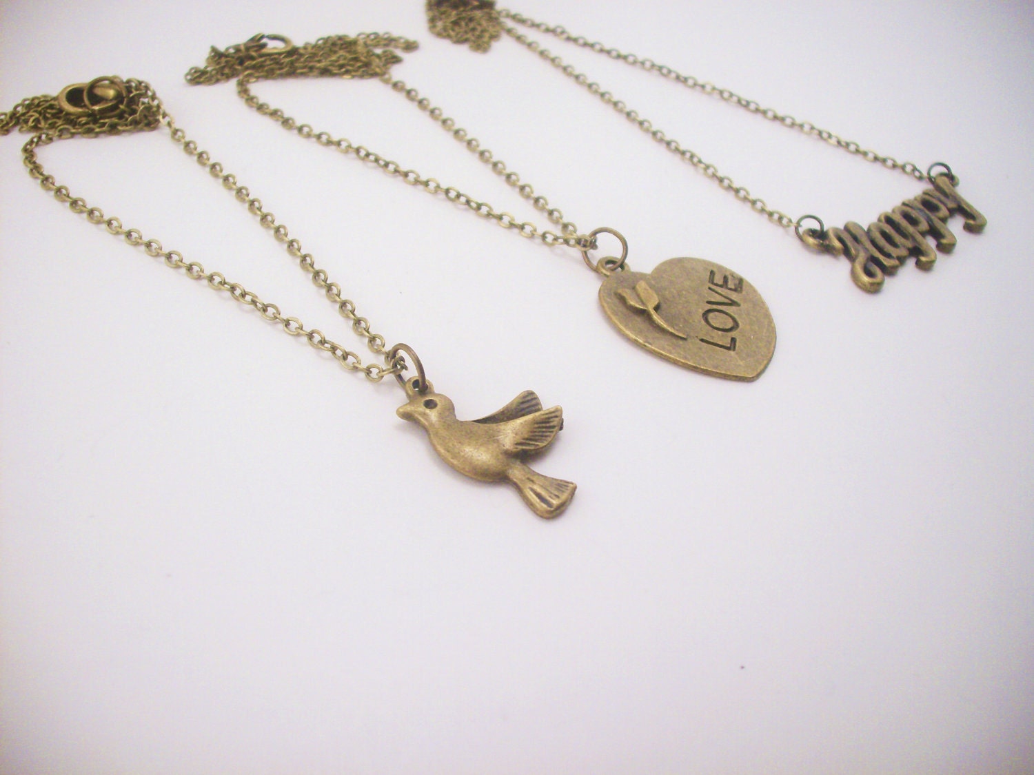 Set of three friendship necklaces. Peace, love, happiness. Brass, gold toned. Dove. Heart with flower. Best friend gift.