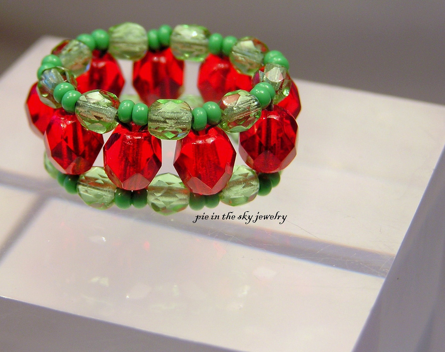 Ring. ruby red and green third angle weave ring