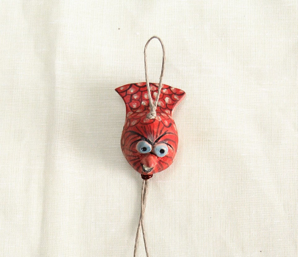 Rouge -------- Ceramic Miniature on String.