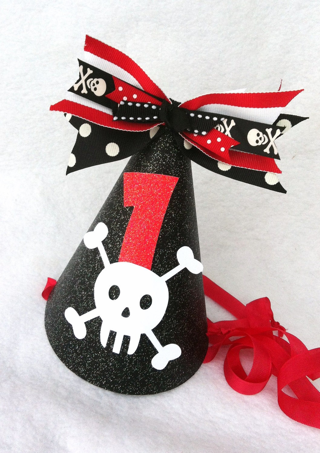 Swashbuckling pirate birthday party hat in black and red with white jollyroger skull crossbones