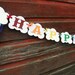 Glittery Rainbow Party Banner in Brights with ribbon streamers and clouds 16 pennants