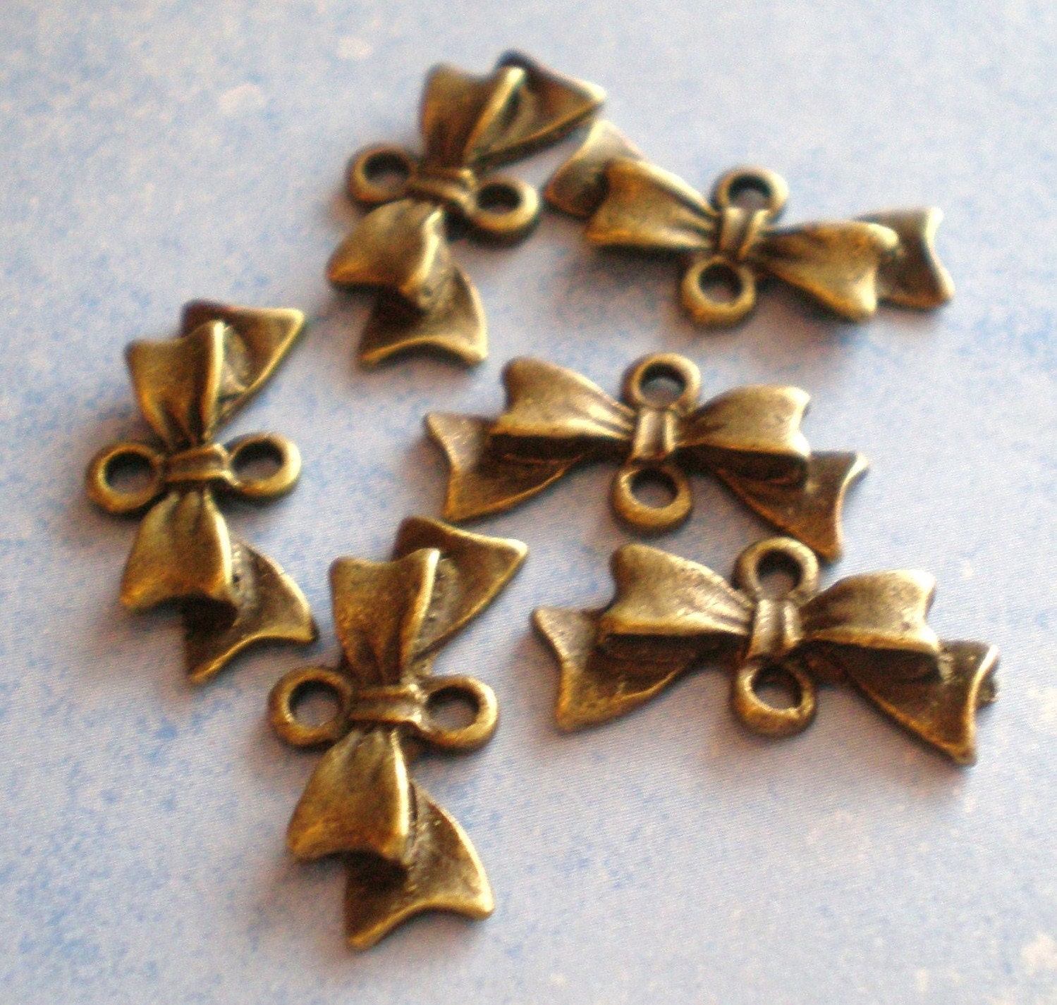 Items similar to 12 Bronze bow jewelry connectors bow charm dangles