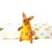 Yellow rabbit critter of the forest with matchbox bed