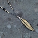 Gold and Black Carved Bone Feather Pendant