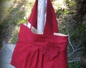 Deep red, pleated purse with rosette