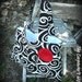 Pleated black and white swirls purse with red rosette