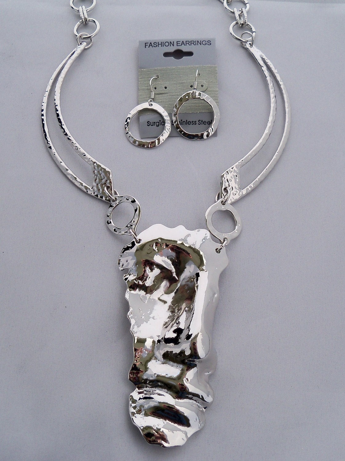 Statement set Inspired by Salvador Dali Half Face Man,Necklace, earrings, chocker Rhodium made by Shoptillyoudropnow on Etsy