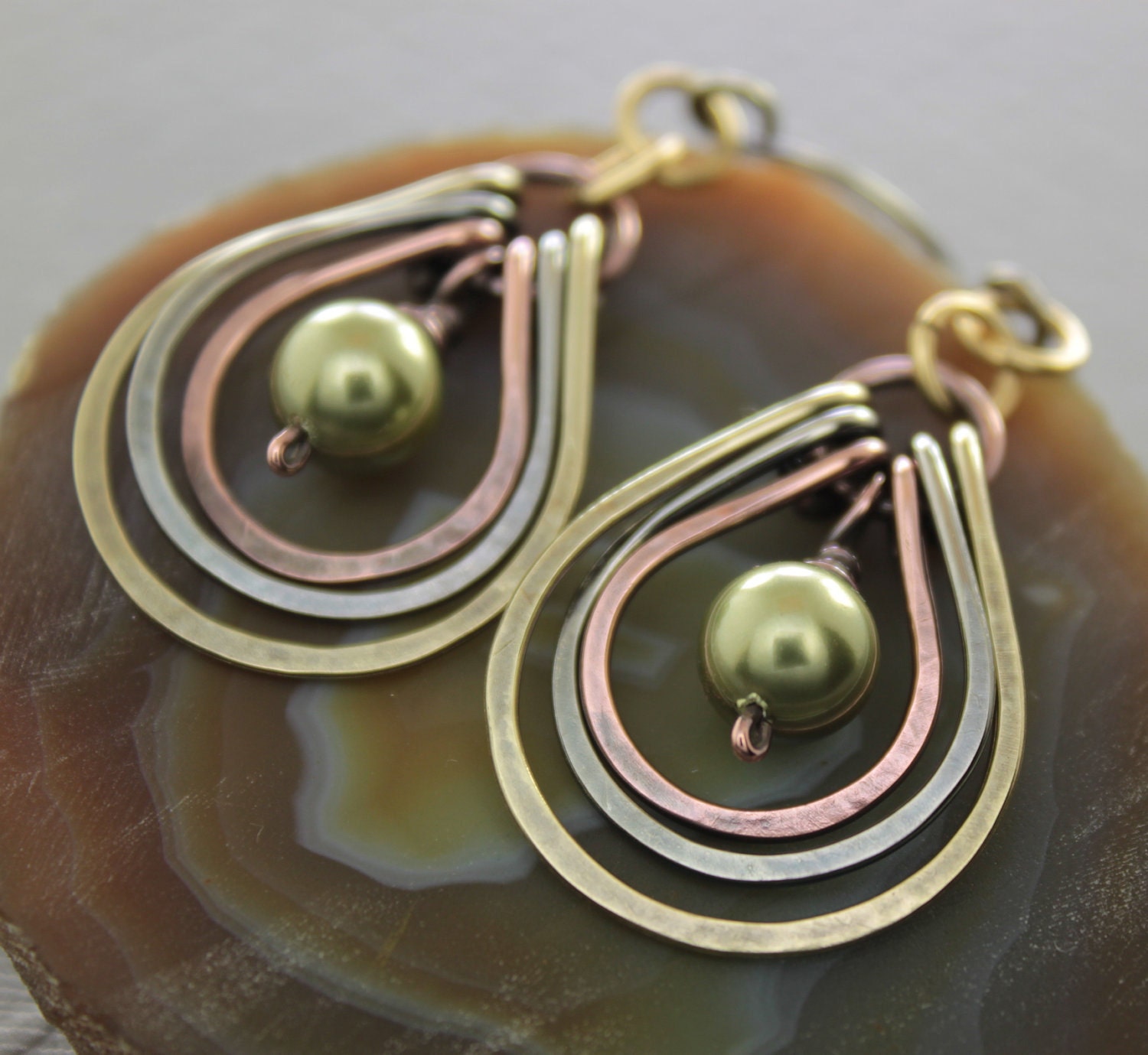Multicolored metal earrings with copper, German silver and brass hoops with green Swarovski pearls