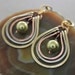 Multicolored metal earrings with copper, German silver and brass hoops with green Swarovski pearls