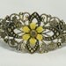 Antiqued gold filigree cuff braclet with hand painted yellow daisey