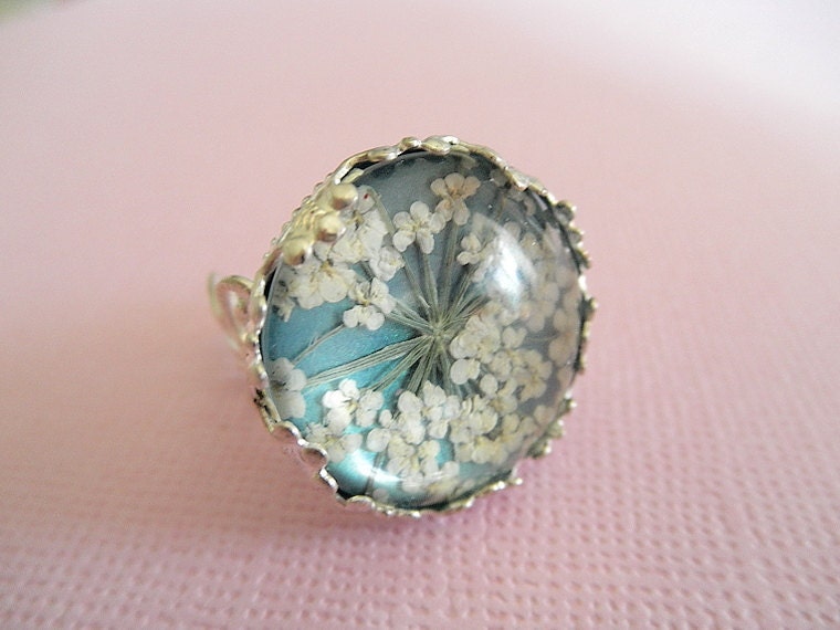 Victorian Filigree Pressed Flower Glass Ring with Queen Anne's Lace Atop Ocean Seafoam Blue Green Background, Symbolizes Peace