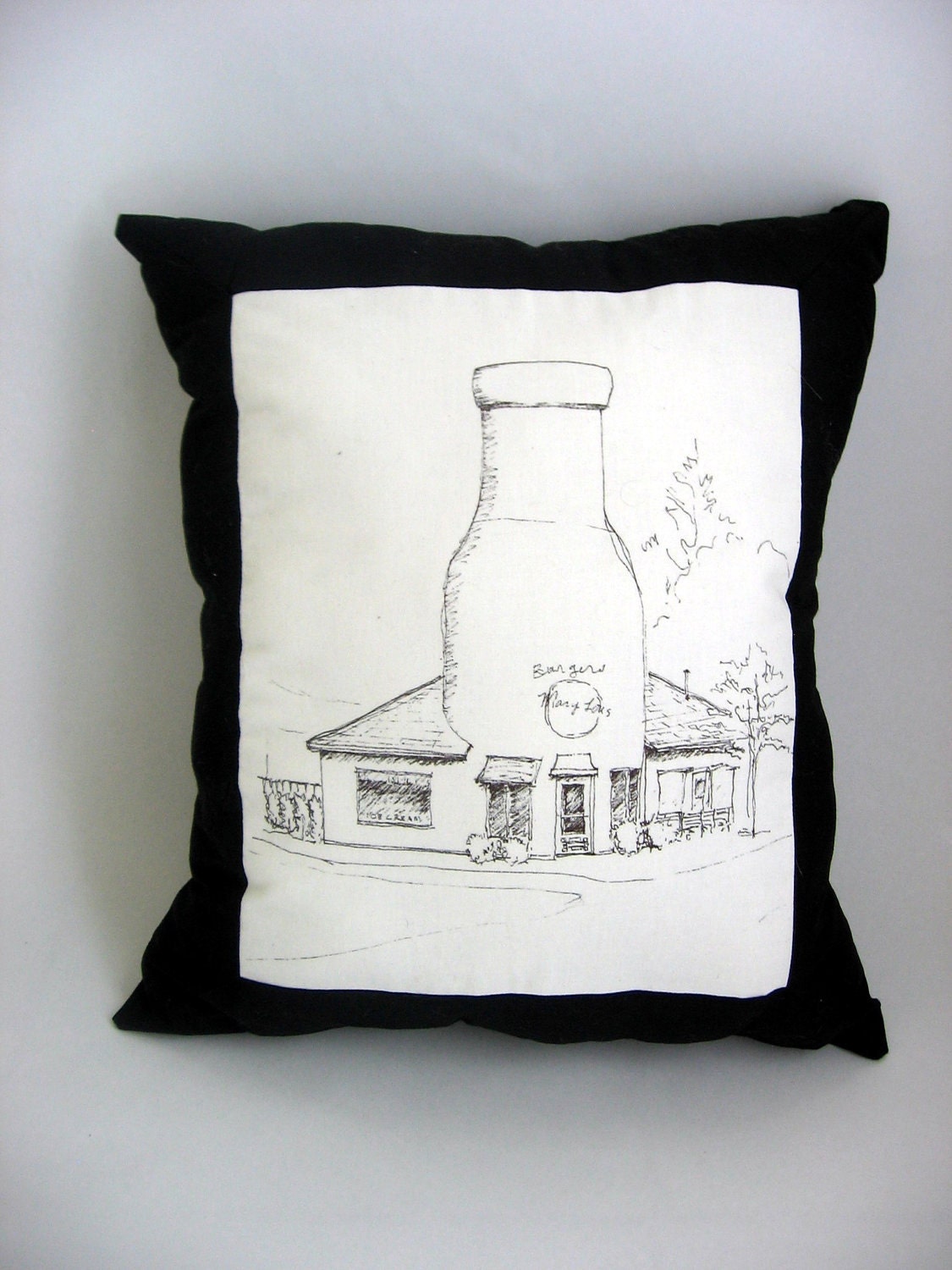 Pillow with a sketch of Mary Lou's Milk Bottle