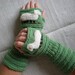 Hand-knitted green wrist warmers with hand needlecrafted sheep