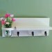 Shelf with jar vase and key hooks