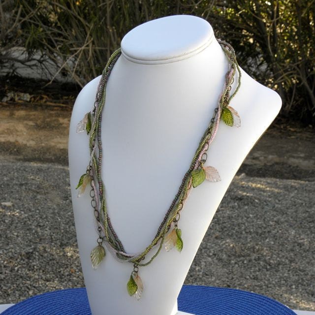 A Captivating Multi Strand Necklace of Handmade Glass Leaves, Brass Chain and Pastel Colored Seed Beads is Absolutely Dreamy.