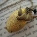 PEETAS LOCKET - Hunger Games Inspired Heirloom Style Accordion Locket Necklace with Mockingjay, Pearl and Coal Black Faceted Crystal