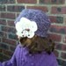 Purple Hat with a big white  flower
