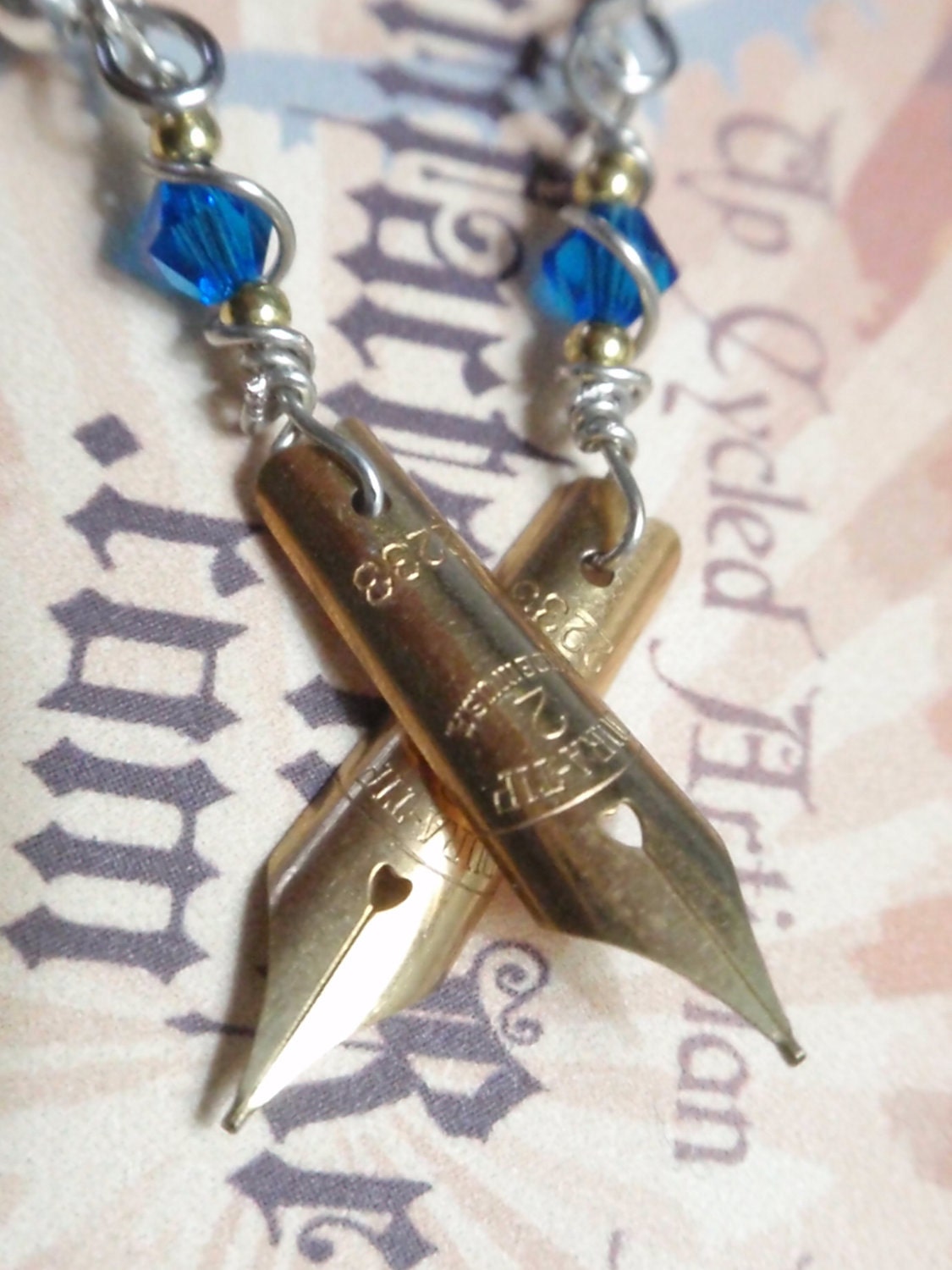 Small Fountain Ink Pen Nib Earrings The Artist Statement. Dura Tip N0 2 nibs Made in USA. up cycled ArtifactsnRelics Sapphire Blue crystals