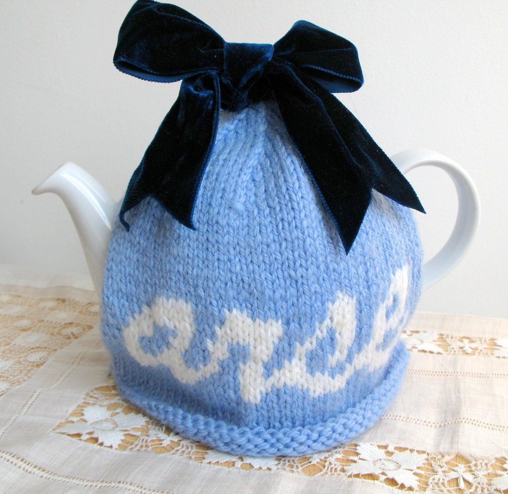 Rude "arse" hand knitted wool tea cosy in blue wool with velvet ribbon