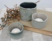 Set of three small porcelain vessels or votives