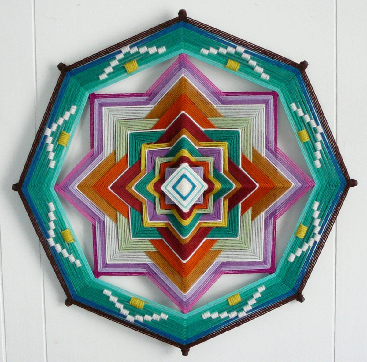 Mother Earth, Father Sky, a 16 inch, 8-sided Ojo de Dios yarn mandala, by custom order