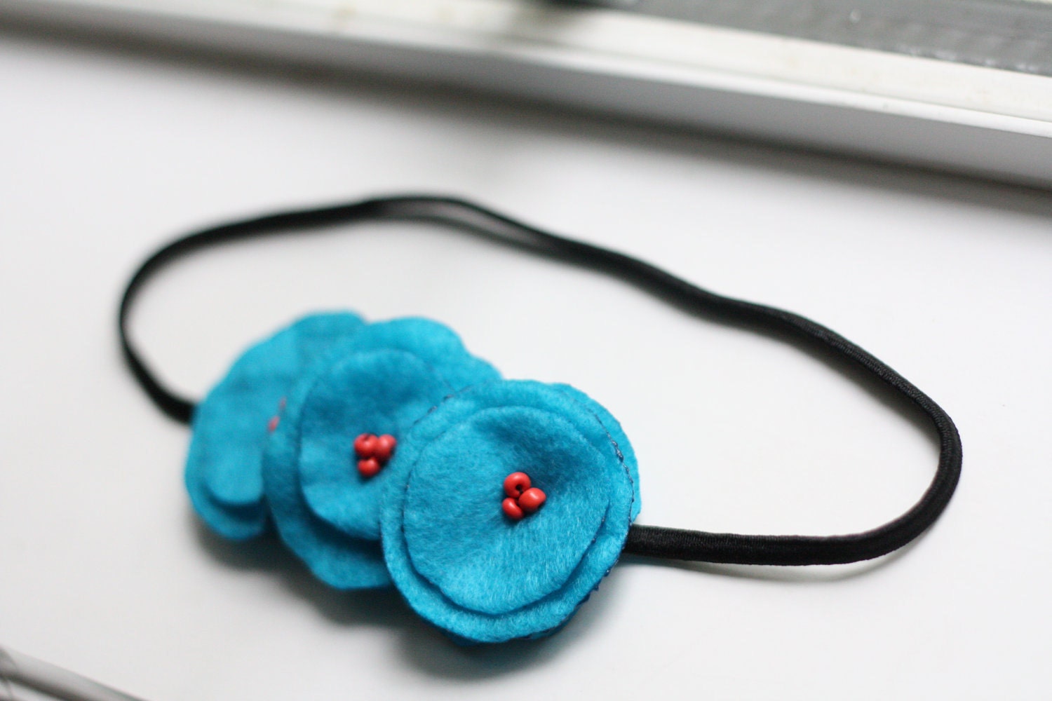 in a whimsical wonderland poppy garland headband.